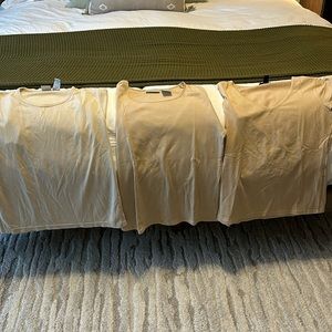 Three women’s tan/beige short sleeve tops.